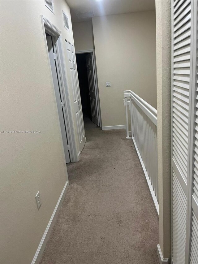 corridor featuring carpet flooring