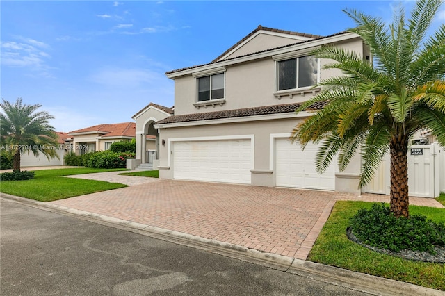 view of front of home with a garage and a front lawn