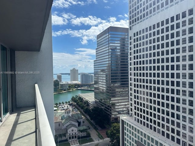 balcony featuring a water view and a view of city