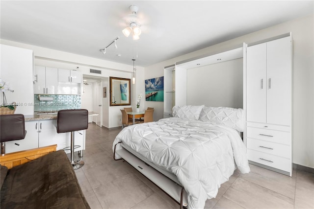 bedroom with rail lighting and ceiling fan