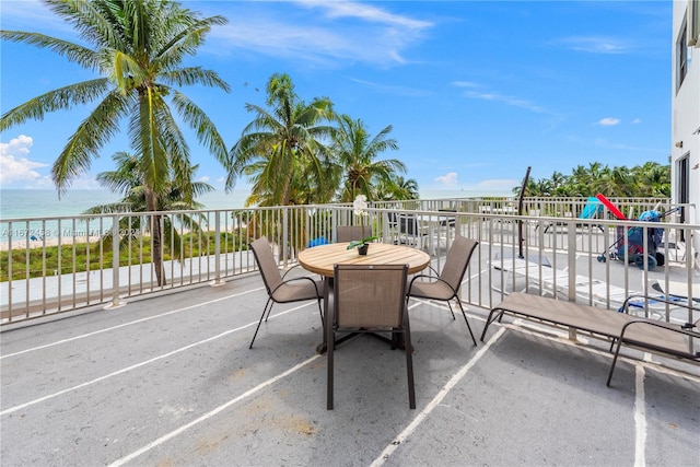 view of patio featuring a balcony and a water view