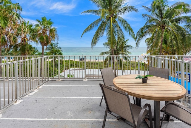 view of patio featuring a view of the beach and a water view