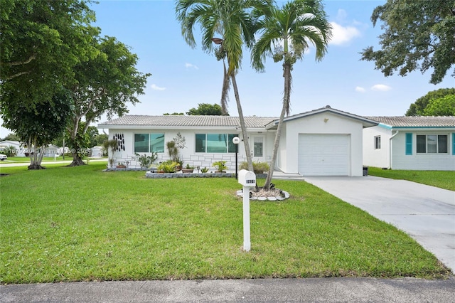 single story home featuring a front lawn and a garage