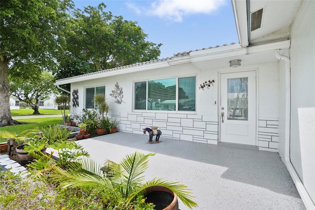 property entrance with a patio