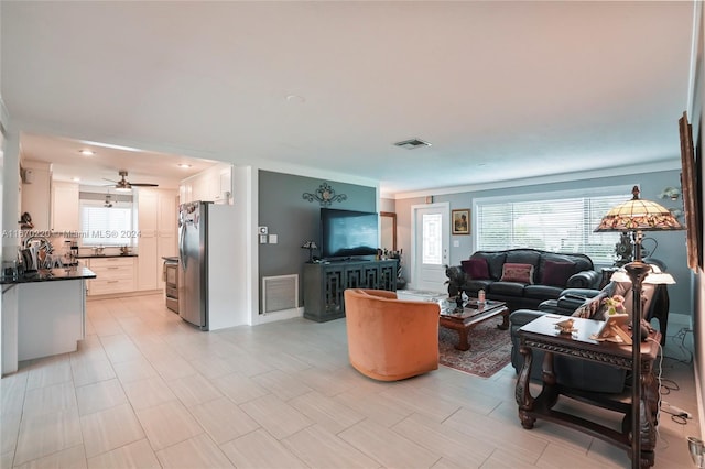 living room with ceiling fan and plenty of natural light