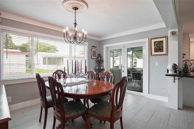 dining room with an inviting chandelier, ornamental molding, and a healthy amount of sunlight