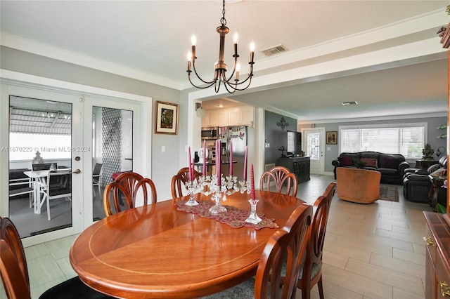 dining area featuring an inviting chandelier and crown molding