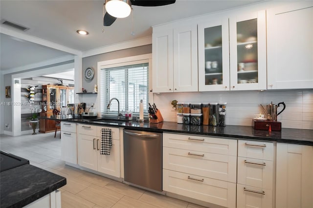 kitchen with white cabinets, sink, backsplash, dishwasher, and dark stone countertops