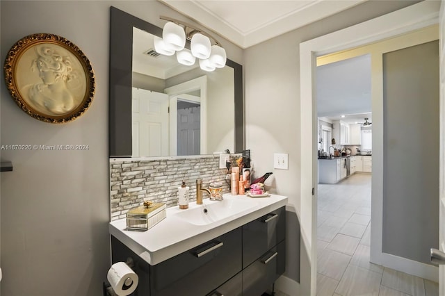 bathroom with vanity, crown molding, tile patterned flooring, and tasteful backsplash