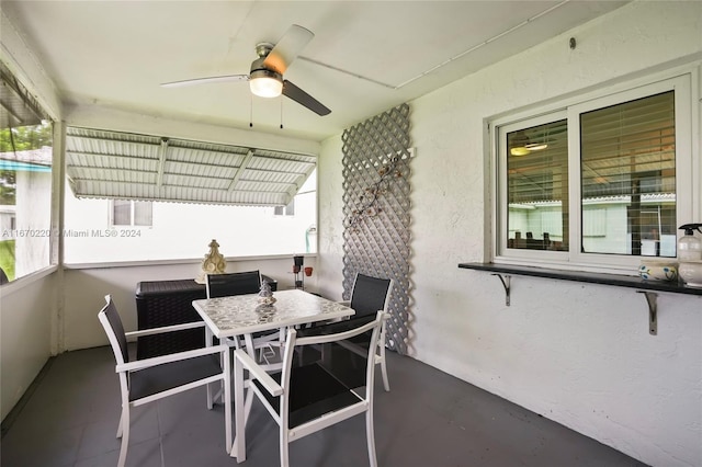 sunroom featuring ceiling fan