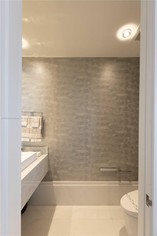 bathroom with toilet and tile patterned flooring