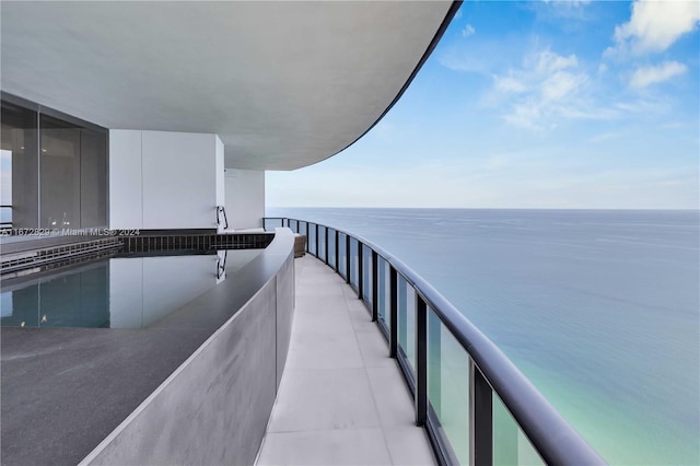 balcony featuring a water view