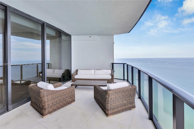 balcony featuring an outdoor hangout area and a water view