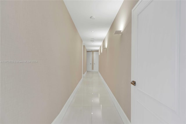 corridor with light tile patterned floors