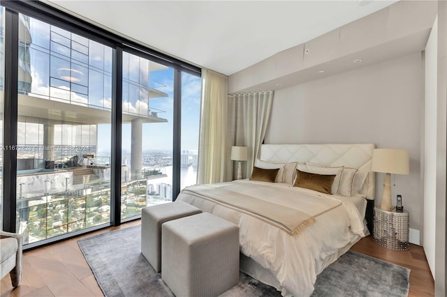 bedroom featuring floor to ceiling windows and hardwood / wood-style flooring