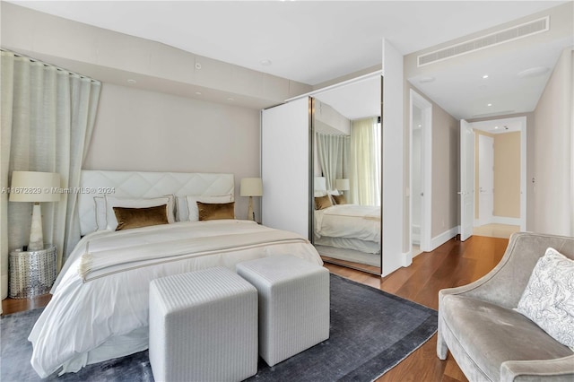 bedroom with dark wood-type flooring