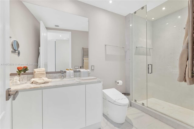 bathroom featuring vanity, a shower with shower door, and toilet