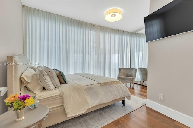 bedroom with hardwood / wood-style flooring