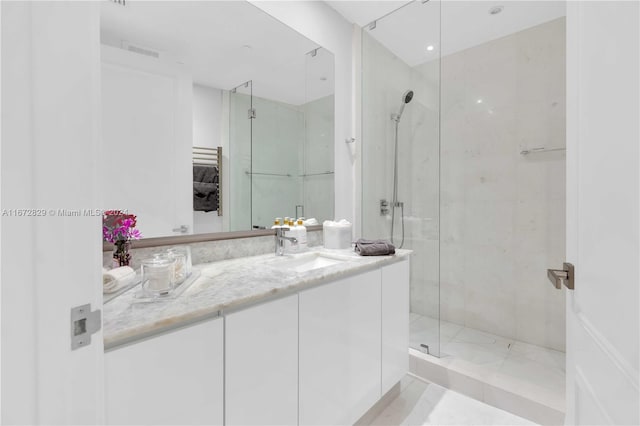 bathroom featuring a stall shower and vanity