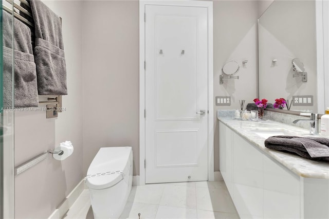 bathroom with vanity, toilet, and baseboards