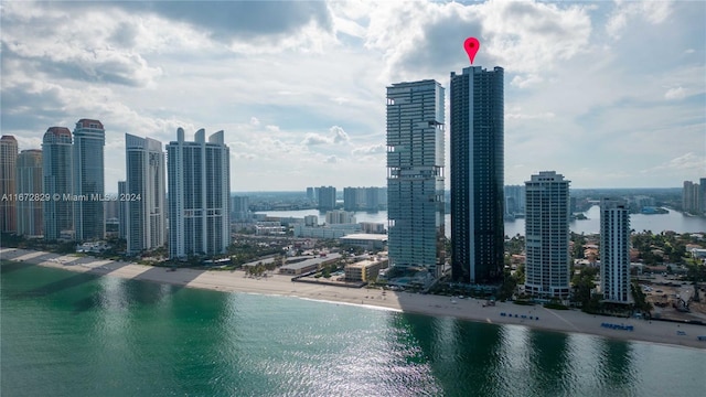 view of city featuring a water view and a beach view