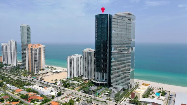 birds eye view of property with a view of the beach and a water view