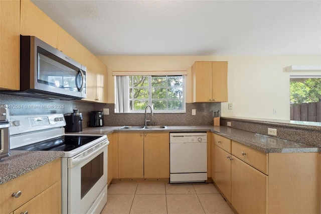 kitchen with backsplash, white appliances, sink, light tile patterned floors, and light brown cabinets