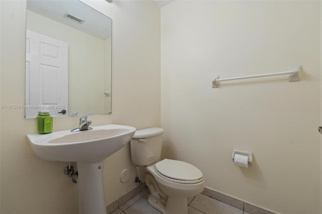 bathroom with tile patterned floors and toilet