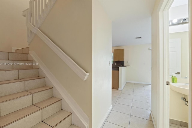 staircase featuring tile patterned flooring