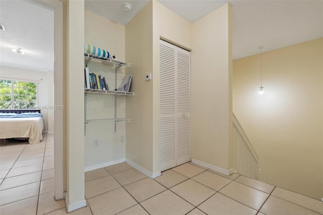 corridor with light tile patterned floors