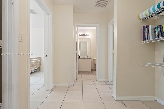 corridor featuring light tile patterned flooring