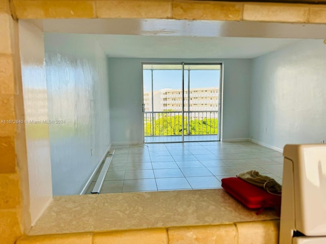 empty room featuring tile patterned floors and baseboards