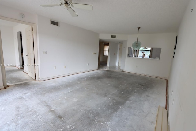 10360 NW 30th Ct Unit 204, Sunrise, FL 33322 - empty room with concrete floors, a ceiling fan, a smoke detector, and a chandelier