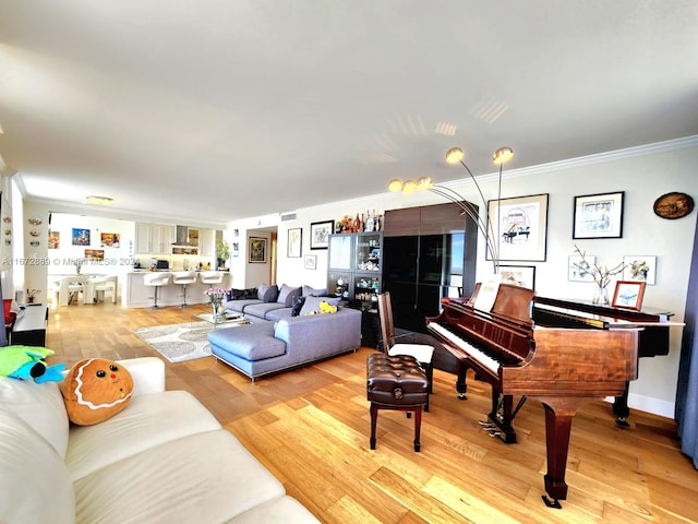 living room with light wood-type flooring and crown molding