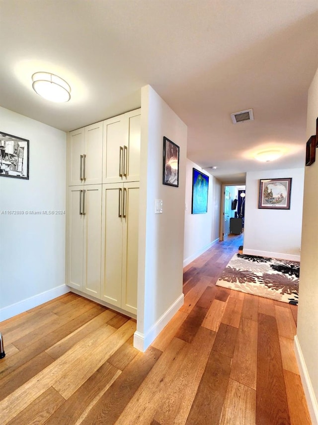 corridor with light wood-type flooring