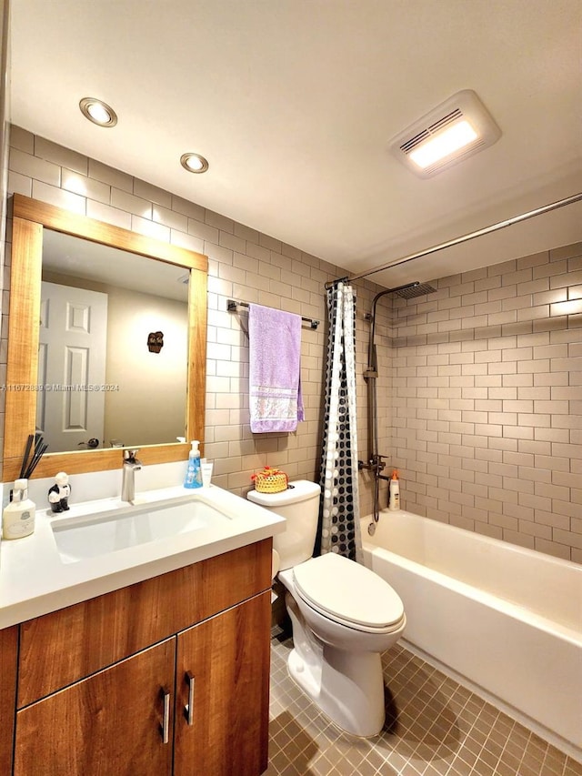 full bathroom with vanity, toilet, shower / bath combo, tile walls, and tile patterned flooring