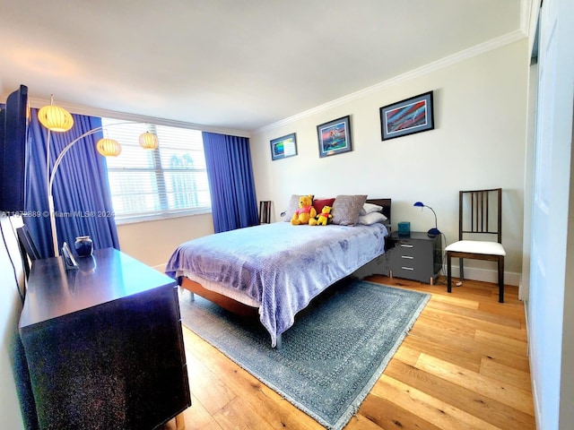 bedroom featuring ornamental molding and wood-type flooring