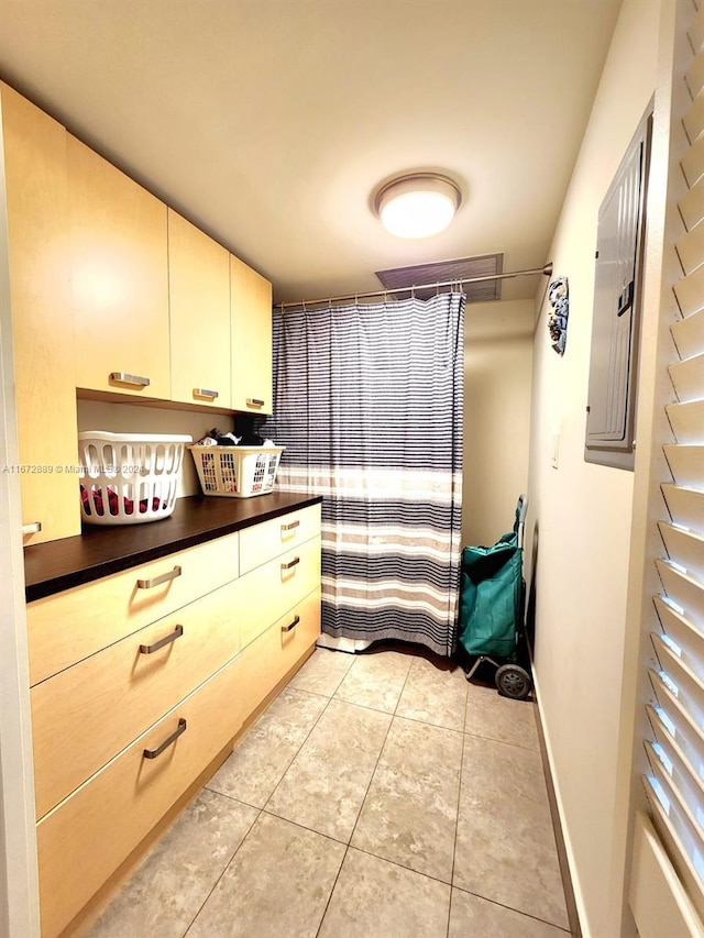 bathroom with electric panel and tile patterned floors