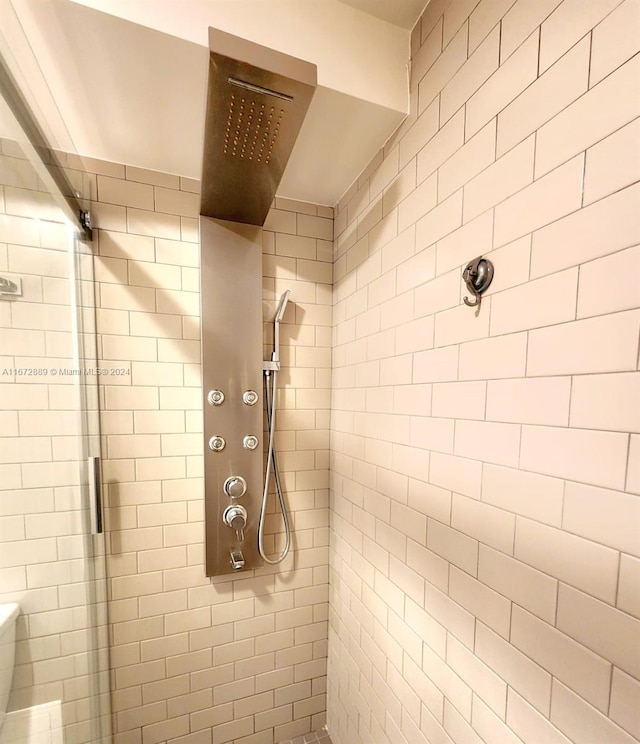 bathroom with a tile shower