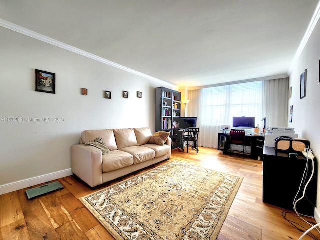 living room with light wood-type flooring and crown molding