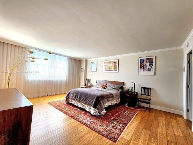 bedroom featuring hardwood / wood-style floors and crown molding