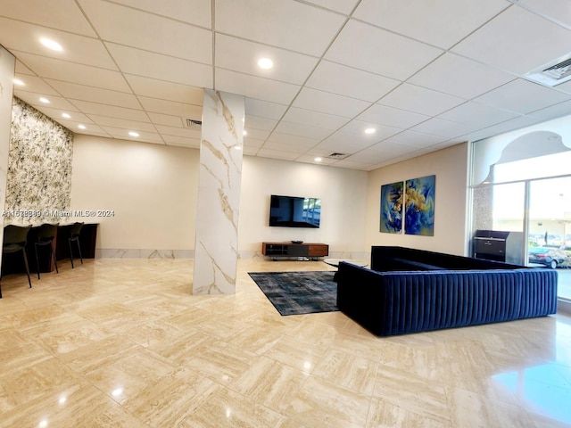 living room with a paneled ceiling