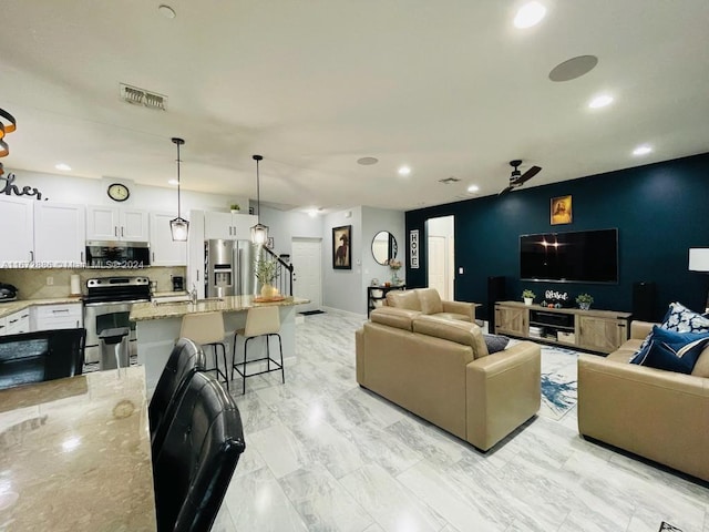 living room featuring ceiling fan