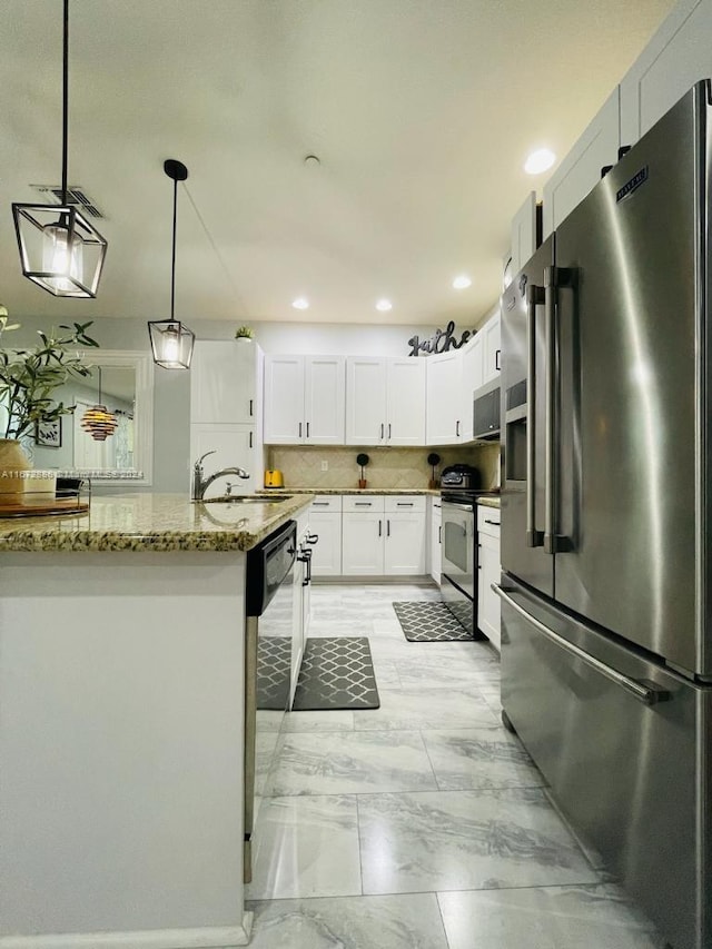 kitchen featuring pendant lighting, sink, white cabinetry, appliances with stainless steel finishes, and stone countertops