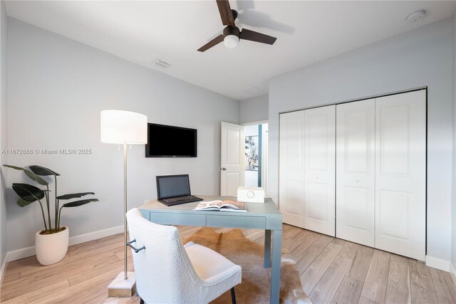 bedroom with light hardwood / wood-style floors and a closet