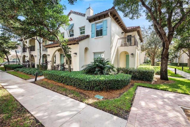 4184 Cascada Cir, Cooper City, FL 33024 - mediterranean / spanish-style home with a balcony, a tiled roof, a chimney, and stucco siding