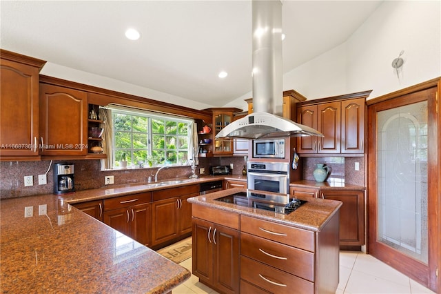 kitchen featuring appliances with stainless steel finishes, backsplash, island range hood, a center island, and sink