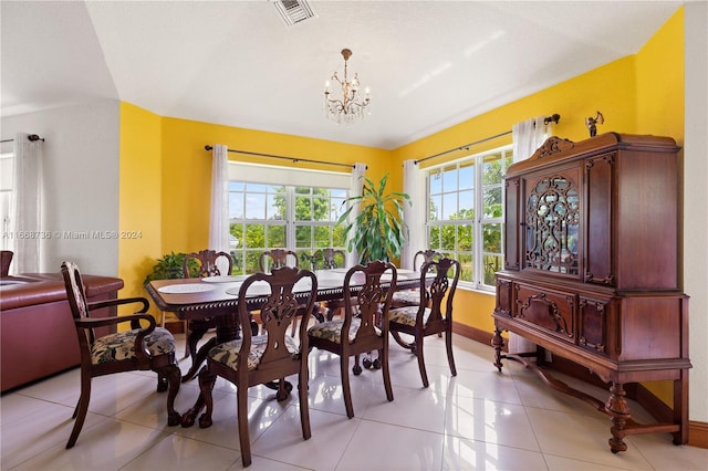 tiled dining room featuring a notable chandelier