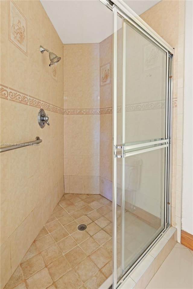 bathroom with tile patterned flooring and an enclosed shower