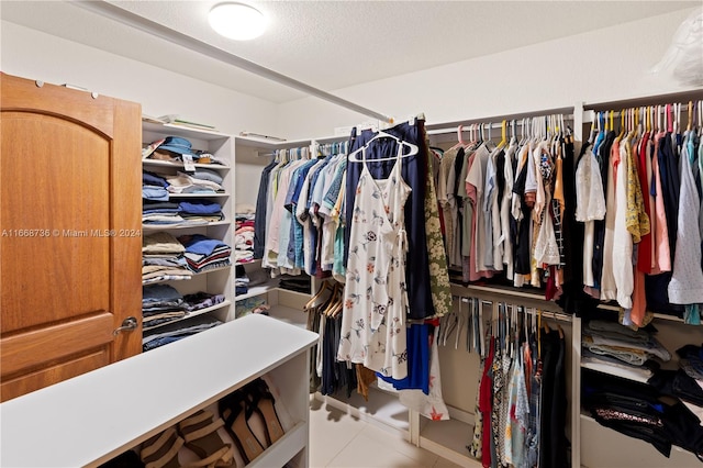 walk in closet with light tile patterned floors